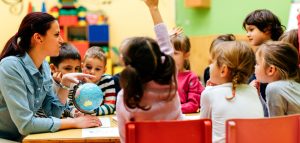 Preschool teacher and children in classroom
