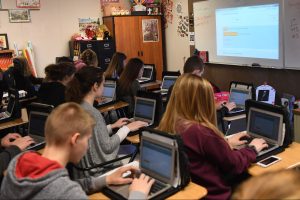 Students using laptops in classroom
