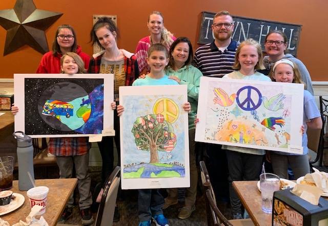 Students with their artwork
